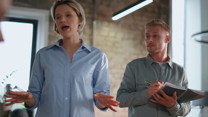 Woman director sharing ideas with professional business team in office close up.