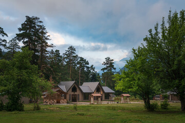 Obraz premium View of a detached chalet in the northern foothills of the Caucasus Mountains near the village of Arkhyz on a summer day, Karachay-Cherkessia, Russia