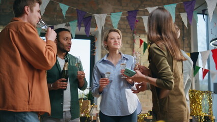 Businesspeople celebrating company birthday standing at festive decorated office