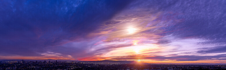 Fototapeta na wymiar Multiple exposure Panorama of a sunset with a colorful cloudscape