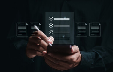Business performance checklist, Business evaluation, project approval and enhancing business performance. Businessman use smartphone to approve documents on virtual screen.