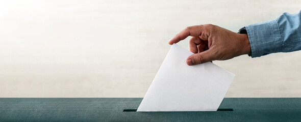 Hand holding ballot paper for election vote concept white background. copy space