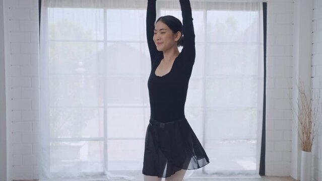 Asian young beautiful woman practice dancing ballet rehearsing at home. 