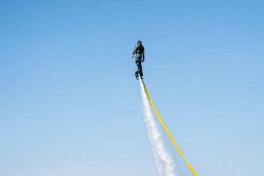 man flies on a FlyBoard against the background of the sky. Extreme sport