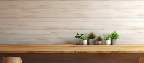 A rectangle wooden table with houseplants in flowerpots on top, placed in front of a hardwood wall. The wood stain enhances the natural beauty of the setup