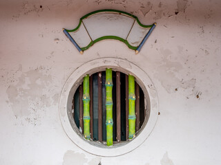 Green bamboo bars on a window in a building in Taipei