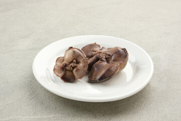 Boiled chicken liver on white plate
