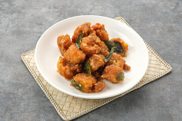 Salted egg fried shrimp or udang telur asin with curry leaves
