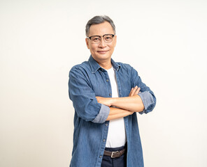 Handsome asian mature old man standing arm crossed on isolated white background. Happy Portrait of cheerful smiling senior asian man looking at camera. Mature People and lifestyle