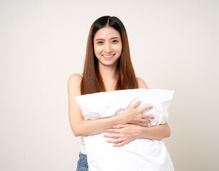 Fototapeta premium Young beautiful asian woman sleeping hugging soft pillow. Cute smiling Drowsy female on isolated white background.