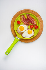 American breakfast. 
Fried eggs with bacon, tomatoes. Freshly squeezed juice