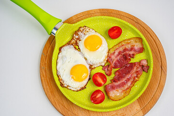 American breakfast. 
Fried eggs with bacon, tomatoes. Freshly squeezed juice