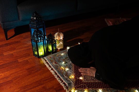 Woman Praying on a Prayer Mat on the Background of Ramadan Lanterns, Uskudar Istanbul, Turkiye (Turkey)