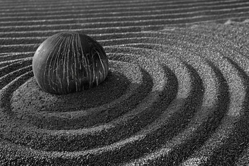 Tuinposter A black zen garden, raked patterns in the stone. The photographer captures tranquility and balance © Formoney