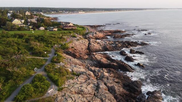 drone above marginal way trail on the coastline of Ogunquit Maine USA tourist pedestrian walking and bicycling the coastline at sunset 