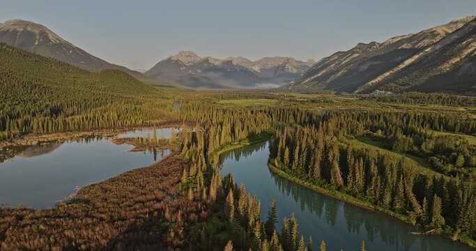 Banff AB Canada Aerial v26 drone flyover Bow River capturing stunning Canadian wilderness, lush forested valleys and breathtaking mountain vistas at sunrise - Shot with Mavic 3 Pro Cine - July 2023