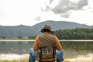 Enjoy moment of Handsome man fishing as a leisure activity during his vacation at the lake on...