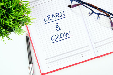 Learn and Grow written in a notebook on the table