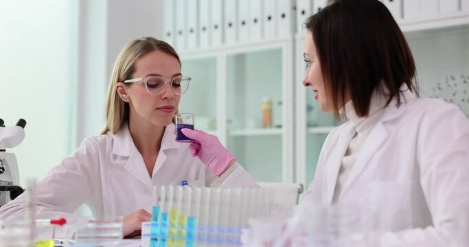 Scientist gives to smell stinky liquid to trainee in lab