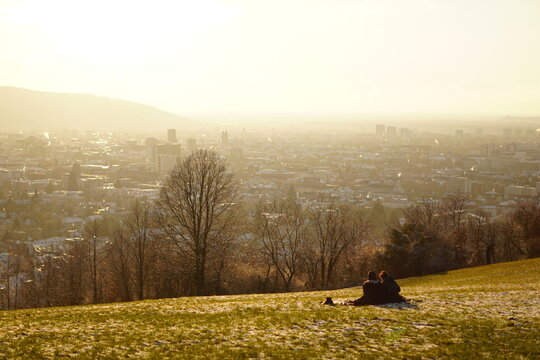 person walking in the park, sunset over the city view in Freiburg im Breisgau, Germany