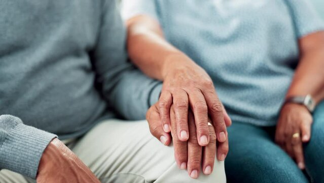 Love, holding hands and senior couple on sofa together with support, comfort and counseling in nursing home. Marriage therapy, old man and woman on couch with care, kindness and respect in retirement