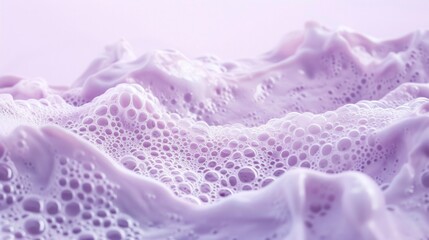Soft pastel pink foam delicately textured against a lavender backdrop, epitomizing minimalist...