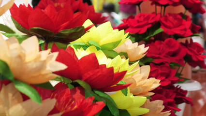 Bunches of artificial flowers displayed in a street shop