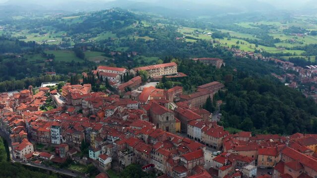 Aerial View Of Red Rooftops Of Vicoforte Commune Buildings. Pull Back Shot, Ascending Shot