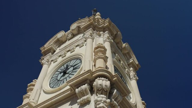 A stunning view of the Edificio Correos clock, where the Mascleta took place. Its intricate eclectic architecture reflects the dominant style of its era.