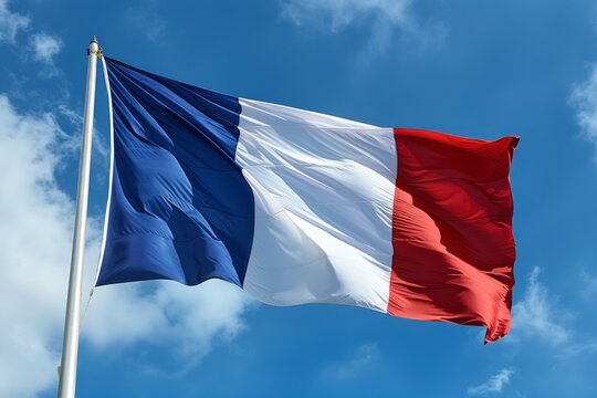 The French flag is fluttering in the wind against the clear blue sky