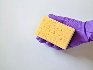 Hand in glove holding sponge