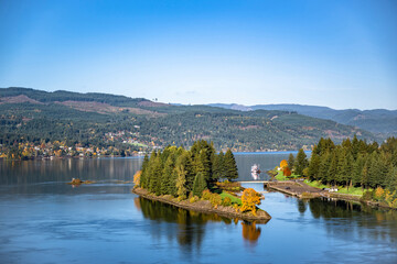 Islet with trees on the Columbia River with a pier for pleasure river boats in the Columbia Gorge Area