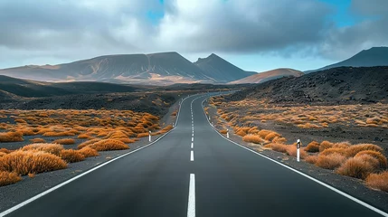 Poster Image related to unexplored road journeys and adventures.Road through the scenic landscape to the destination in Lanzarote natural park. © Naknakhone