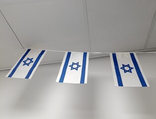 Independence Day Elegance: Garland of Israeli Flags in Office Setting