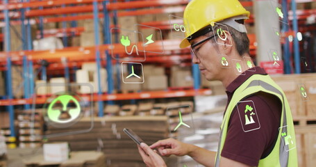 Image of eco icons and data processing over biracial man working in warehouse