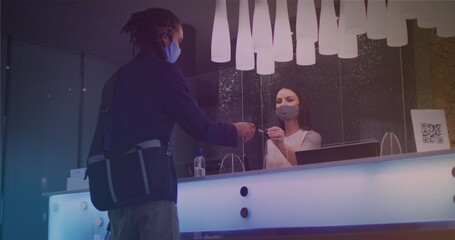 Image of light spots over african american man with face mask taking credit card