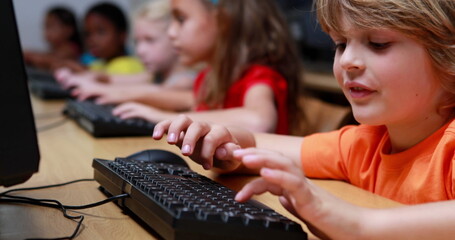Diverse students are engaged in a computer lab at school