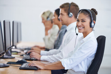 Callcenter, portrait and phone call with woman, typing on computer and consultant at customer support. Headset, telemarketing and client service agent at help desk with teamwork in coworking space