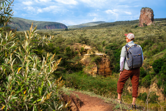 Tourist looking at the scenery of the Hells Gate National Park, Kenya