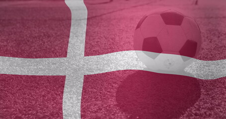 Image of waving denmark flag over football balll