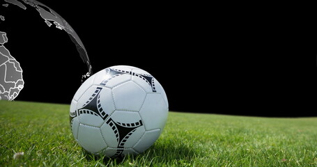 Image of football ball on grass over globe