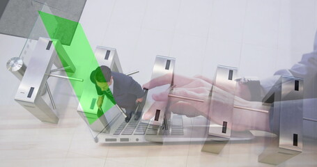 Image of hands using laptop with green screen over businessman passing through station turnstile