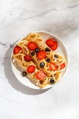 lace pancakes with blueberries and strawberries