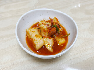 Radish kimchi in a small bowl