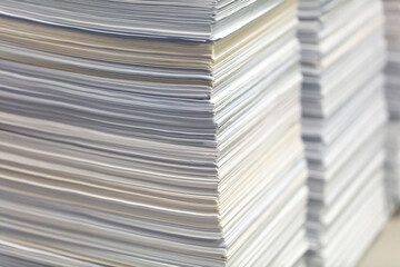 Stacks of papers on a table in the office