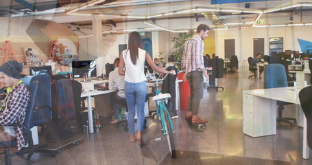 Image of hands using laptop, over colleagues at creative office with bike and on hoverboard