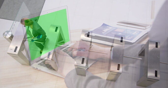Image of hands using laptop with green screen, over businesswomen walking through turnstiles - Powered by Adobe