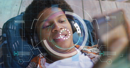 Image of data processing over african american man using smartphone