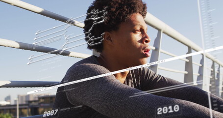 Image of data processing over african american man sitting