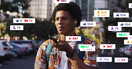 Image of media icons over african american man using smartphone